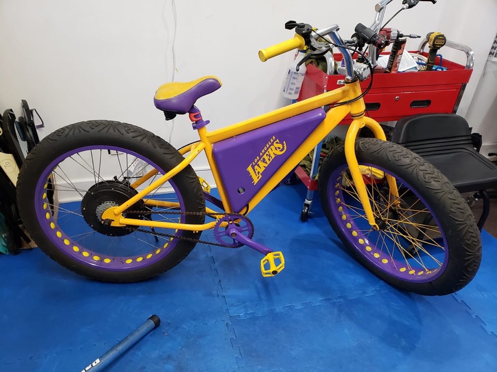 A customer's Lakers-liveried bike on the Strand shop floor, converted with a rear hub motor.